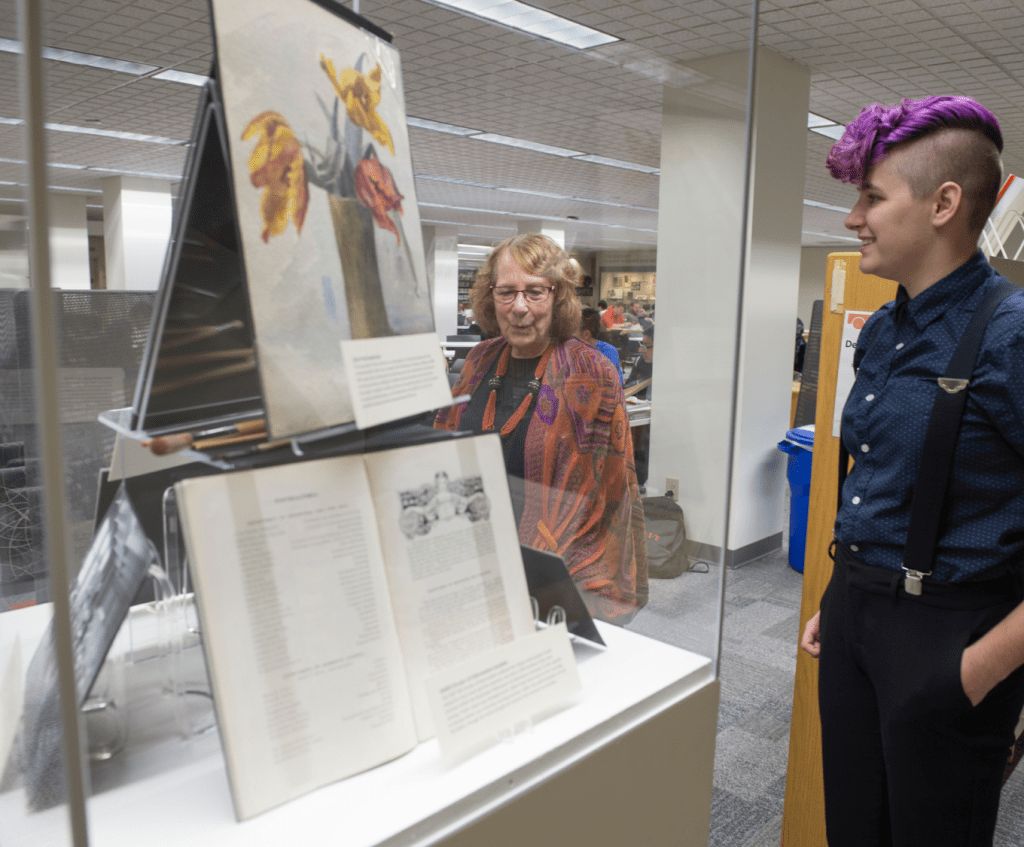 Exhibition curated by Fall 2018 Cultural Informatics course at RIT. Amber DeStevens explains the story of Lillian Pratt to Prof. Tina Lent.